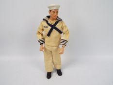 Palitoy, Action Man - A dark brown painted hard head Action Man in GI Joe Sailor dress uniform.