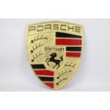 A large cast iron plaque advertising Porsche, approximate size 56.5 cm x 46.