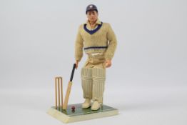 Palitoy, Action Man - A Palitoy dark brown painted hard head Action Man Cricketer.