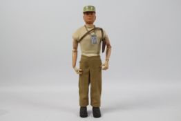 GI Joe, Hasbro - A vintage GI Joe Adventurer figure. The red painted soft head figure is marked 'G.