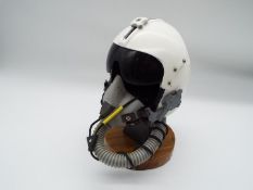 A model depicting a Jet Pilot's helmet mounted on a wooden plinth, approx 21 cm (high),