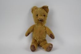 An unmarked vintage teddy bear.