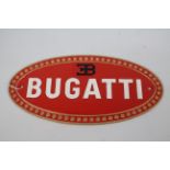 A cast iron, wall mountable, oval plaque marked Bugatti, 17 cm x 35 cm.