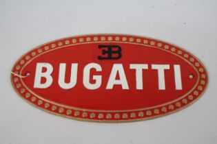 A cast iron, wall mountable, oval plaque marked Bugatti, 17 cm x 35 cm.