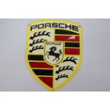 A cast iron wall plaque marked Porsche, 30 cm x 22 cm.