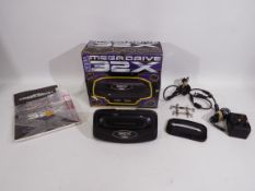 Sega - A boxed Mega Drive 32X console - Box appears in fair condition with some storage wear.