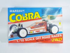 Mardave, Tamiya - A boxed 1/10 scale Mardave Cobra Off Road R/C racer car.