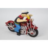 A cast iron model depicting Popeye riding a motorcycle, 16 cm (h).