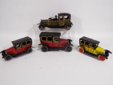 Paya - 4 x clockwork pressed metal vintage cars, a Limousine and three Taxi cabs.