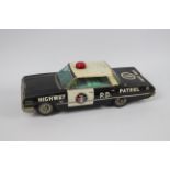 Okuma - A large battery operated pressed metal 1963 Chevrolet Impala Highway Patrol car with