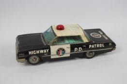 Okuma - A large battery operated pressed metal 1963 Chevrolet Impala Highway Patrol car with