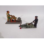 Arnold - 2 x clockwork tinplate models, a man with a grinding wheel and a man with a car jack.
