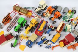 Britains - A collection of unboxed Britains tractors, farm implements and equipment.