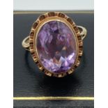 Ladies 9 carat GOLD and AMETHYST RING having large faceted amethyst solitaire to top with attractive