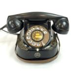 A 1950'S SWISS DIAL TELEPHONE WITH CARRYING HANDLE IN FULL WORKING ORDER BUT HAS A BROKEN BAR. A/F