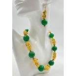 A statement Chinese necklace and earrings set with large (20 mm) green jade beads and gold filled fu