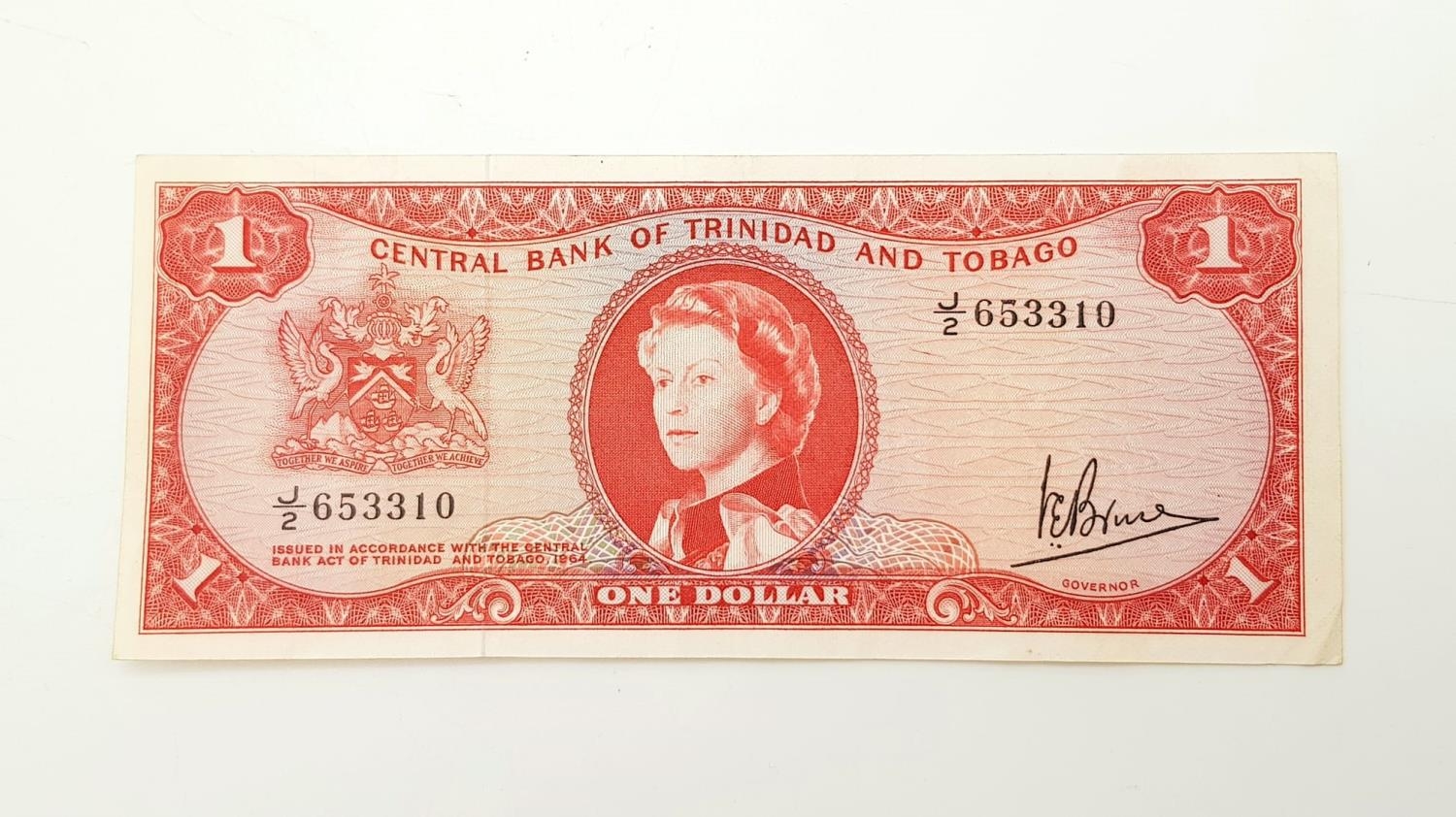 A 1964 Trinidad and Tobago One Dollar Note. Very fine - bordering on uncirculated condition. In