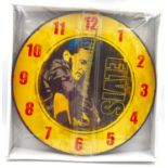 AN ELVIS WALL CLOCK ,UNOPENED. 34cms DIAMETER