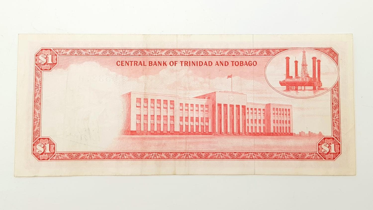 A 1964 Trinidad and Tobago One Dollar Note. Very fine - bordering on uncirculated condition. In - Image 3 of 4