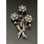 A very attractive 18 K white gold, large brooch with diamonds, designed as a bouquet of flowers. The