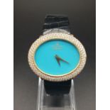 A MONTRE ROYALE OF GENEVA LADIES 18K GOLD DRESS WATCH WITH DIAMOND BEZEL AND TURQUOISE FACE. 36mm