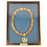 A FRAMED MASONIC GRAND MASTERS CHAIN OF OFFICE. MADE FROM YELLOW METAL. FRAME SIZE 46CM X 60CM.
