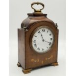 An Antique Buren Mantel Clock. Inlaid dial in a mahogany case with brass handle and feet. Slight