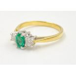 Emerald and diamond trilogy ring set in 18k white and yellow gold, size N weight 3.35g Centre