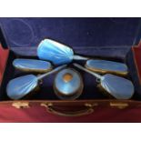 Blue enamel dressing table set consisting six pieces to include mirror brushes and trinket pot ,