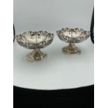 Antique SOLID SILVER pair of raised bonbon dishes having trumpet base and pierced scroll borders.