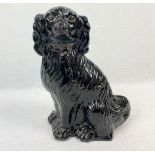 A BLACK CERAMIC SPANIEL SOME DETAIL FADED 35cms IN HEIGHT A/F.