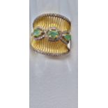 An unusual 14K gold and sterling silver ring with three Colombian emeralds and over 150 diamonds (