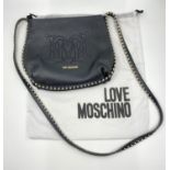 Black leather Love Moschino crossover body bag. Silver studded design around bag and strap. Comes