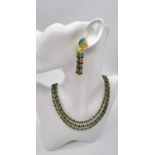 A very elegant, three rows of faceted emeralds and rubies necklace and earrings set, in a