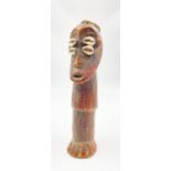 AN EARLY 19TH CENTURY IVORY CARVING OF AN AFRICAN MAN WITH SEA SHELL DECORATION. 20cms in height