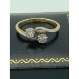18 carat GOLD and PLATINUM ring, having a pair of Diamonds set to top in crossover style.High
