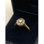 DIAMOND CLUSTER RING set in 18 carat GOLD and PLATINUM. 0.65 carats . 3.25 grams. Size N- N 1/2.