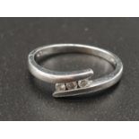 A Platinum and Diamond Three Stone Twist Ring. Size N. 0.10ct. 3g
