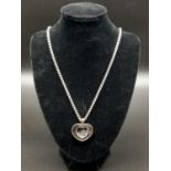 A CHOPARD 18K WHITE GOLD HEART SHAPED PENDANT WITH FLOATING DIAMONDS ON A 56cms 18K GOLD CHAIN. 56.