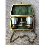 Vintage pair of quality mother of pearl opera glasses ,complete with green hard purse and chain.