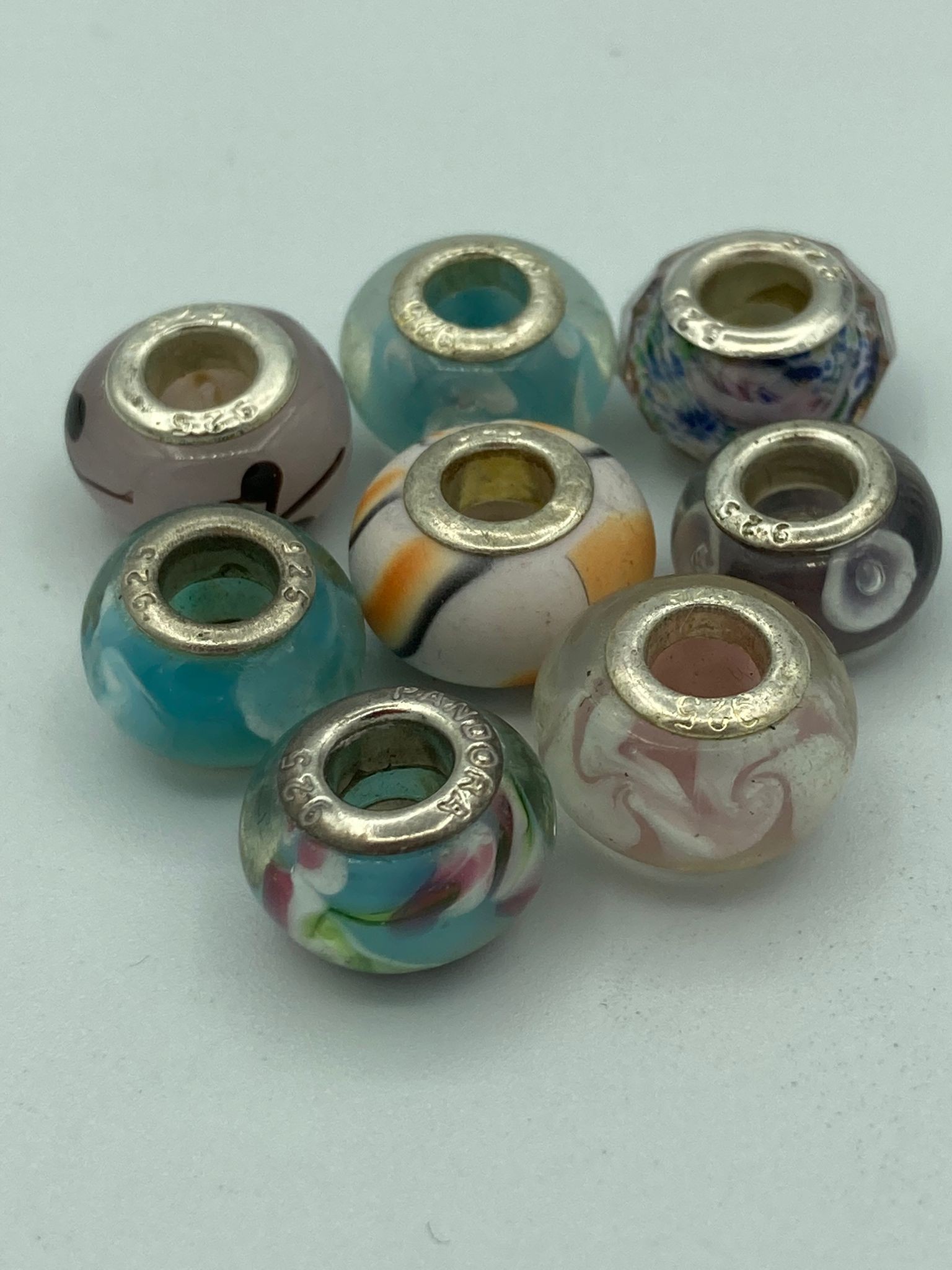 Selection of PANDORA SILVER CHARMS having glass and enamel detail.