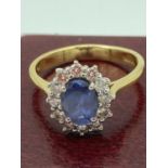 DIAMOND and SAPPHIRE RING having high grade oval sapphire with diamond surround set in 18ct