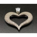 A LARGE 14K WHITE GOLD HEART SHAPED PENDANT ENCRUSTED WITH DIAMONDS.17gms 4.4cms