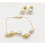 a pair of south sea pearl earrings, in two colours set in 18ct yellow gold with a matching 18ct