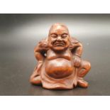 An intricately carved boxwood netsuke of a Sumo wrestler on a ceremonial pose. Signed at the