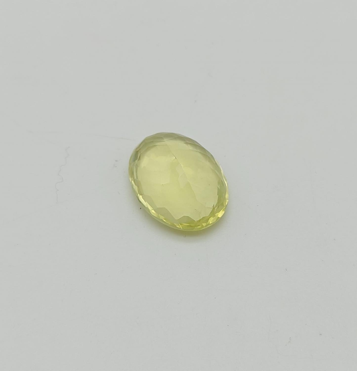 15.08CTS NATURAL LEMON QUARTZ, OVAL MIXED CUT. COMES WITH IDT CERTIFICATION