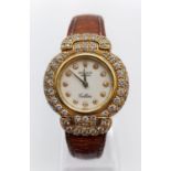 Vintage 18ct gold Rolex Geneve Cellini ladies watch with round face and diamond encrusted bezel