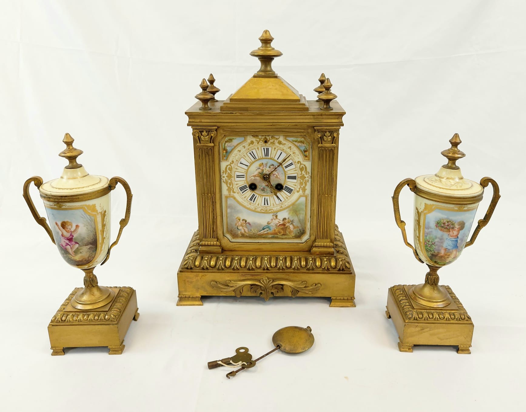 A French Hand-Painted Porcelain and Brass Mantel Clock with Accompanying Pedestalled Chalices. A/F