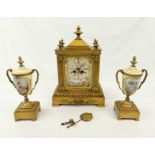 A French Hand-Painted Porcelain and Brass Mantel Clock with Accompanying Pedestalled Chalices. A/F