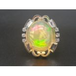 An 18 K white gold ring with a large cabochon opal. Ring size: O/P, opal size: 19 x 15 x 12 mm.